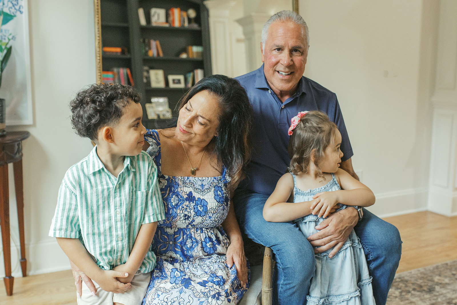 Grandparents with their two young grandchildren during an in-home family photography session in Dacula, GA. Captured by Atlanta family photographer Denay Shook.