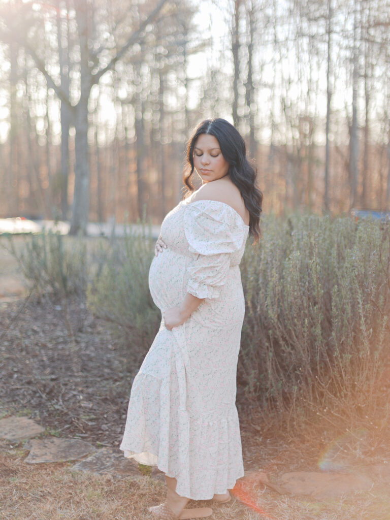 Maternity session in Gwinnett County Georgia featuring expecting mother in flowing dress at sunset in Dacula