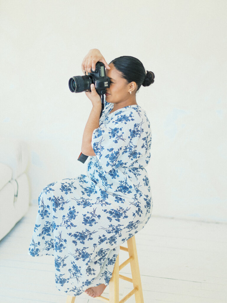 an atlanta photographer poses with her camera for headshots