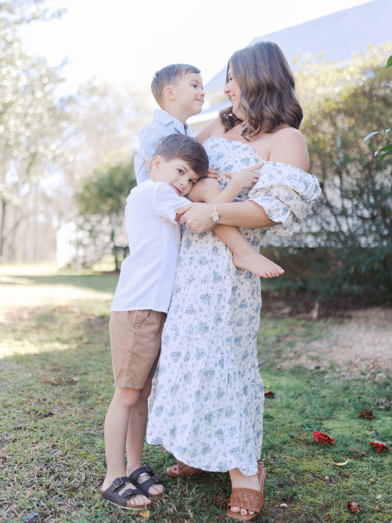 a woman and her children stand in a dacula field